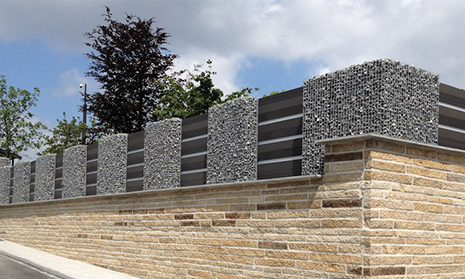 Composite fence with gabions